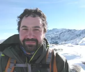 Photo of Ethan Greene with snow covered mountains in the background