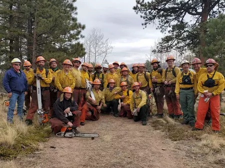 Photo of yellow clad Dept of Corrections wildfire and mitigation teams.