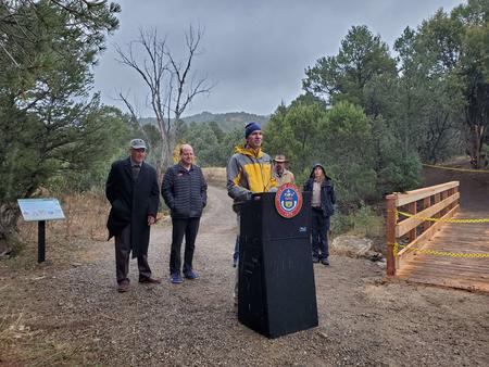 DNR Director Dan Gibbs celebrating new trails at Fishers Peak State Park with Governor Polis and other dignitaries behind