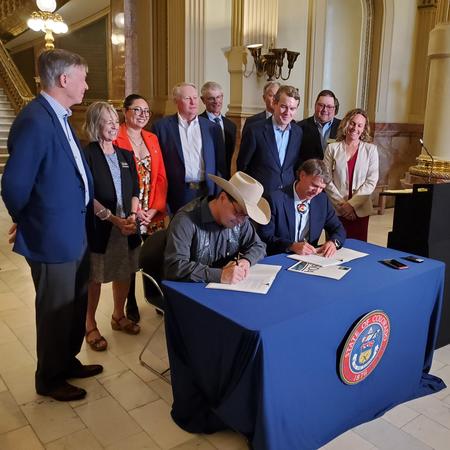 Colorado officials signing agreement to protect more Colorado farmland. 