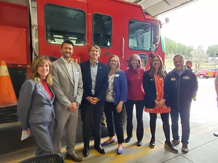 State and Local Officials and employees in front of fire truck 