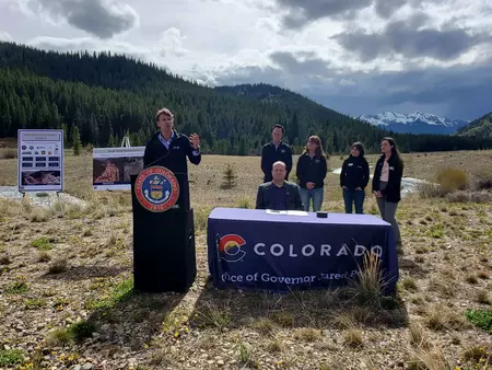 Governor, state employees and legislators at bill signing in Colorado mountains