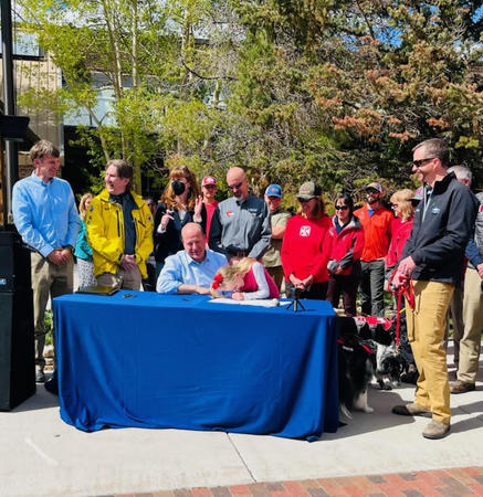 Governor Polis signing wildlife overpass and backcountry search and rescue bill.